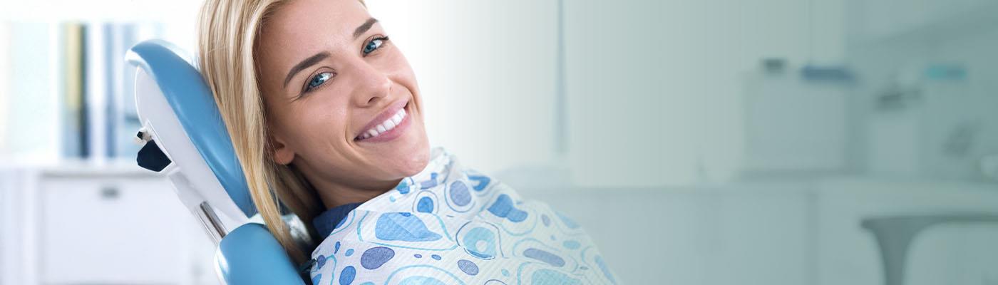dental hygienist looking in patient mouth